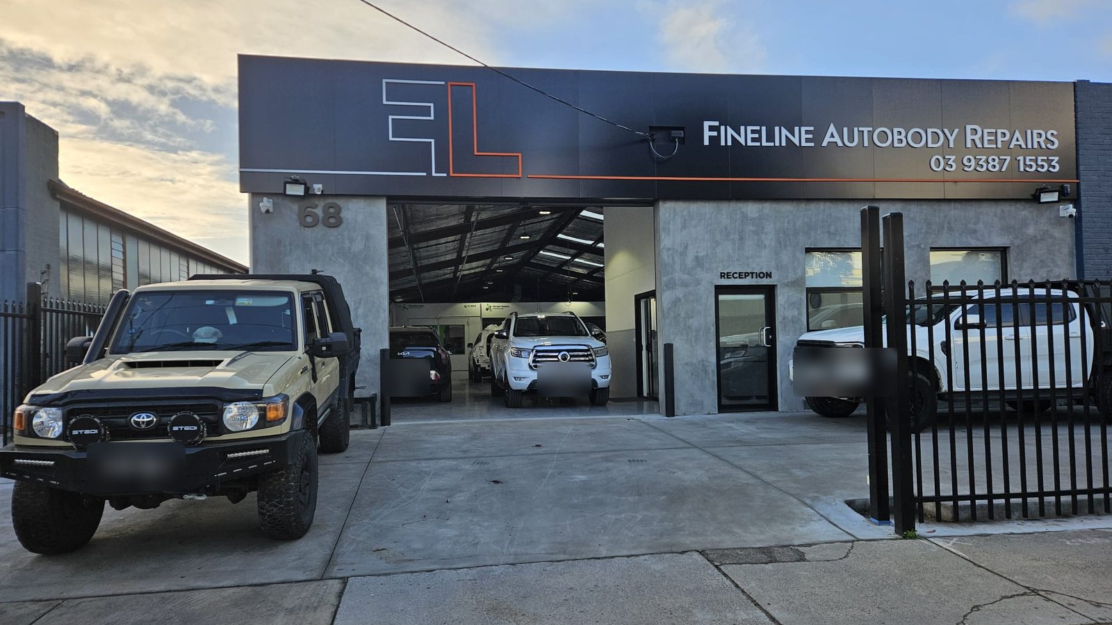 The Fineline Autobody Repairs shopfront in Reservoir, roller door open, cars inside the workshop
