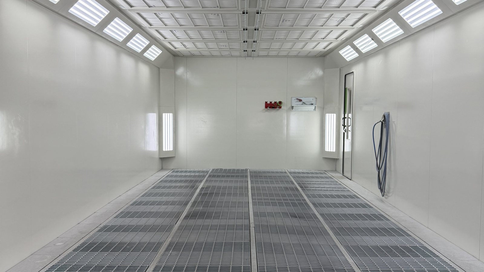 The Fineline spray booth, lit and empty, where a repair is finished and baked